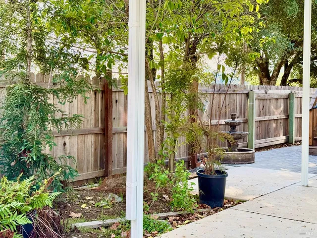 a view of backyard with deck and outdoor seating