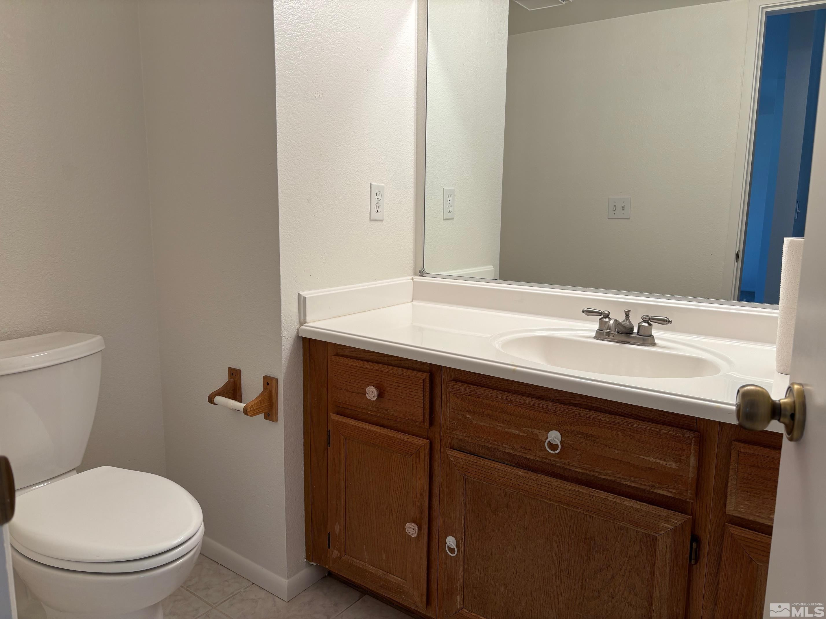 1721 Burnside Drive Sparks, NV 89434 - Photo 5 of 20 a bathroom with a granite countertop toilet sink and mirror