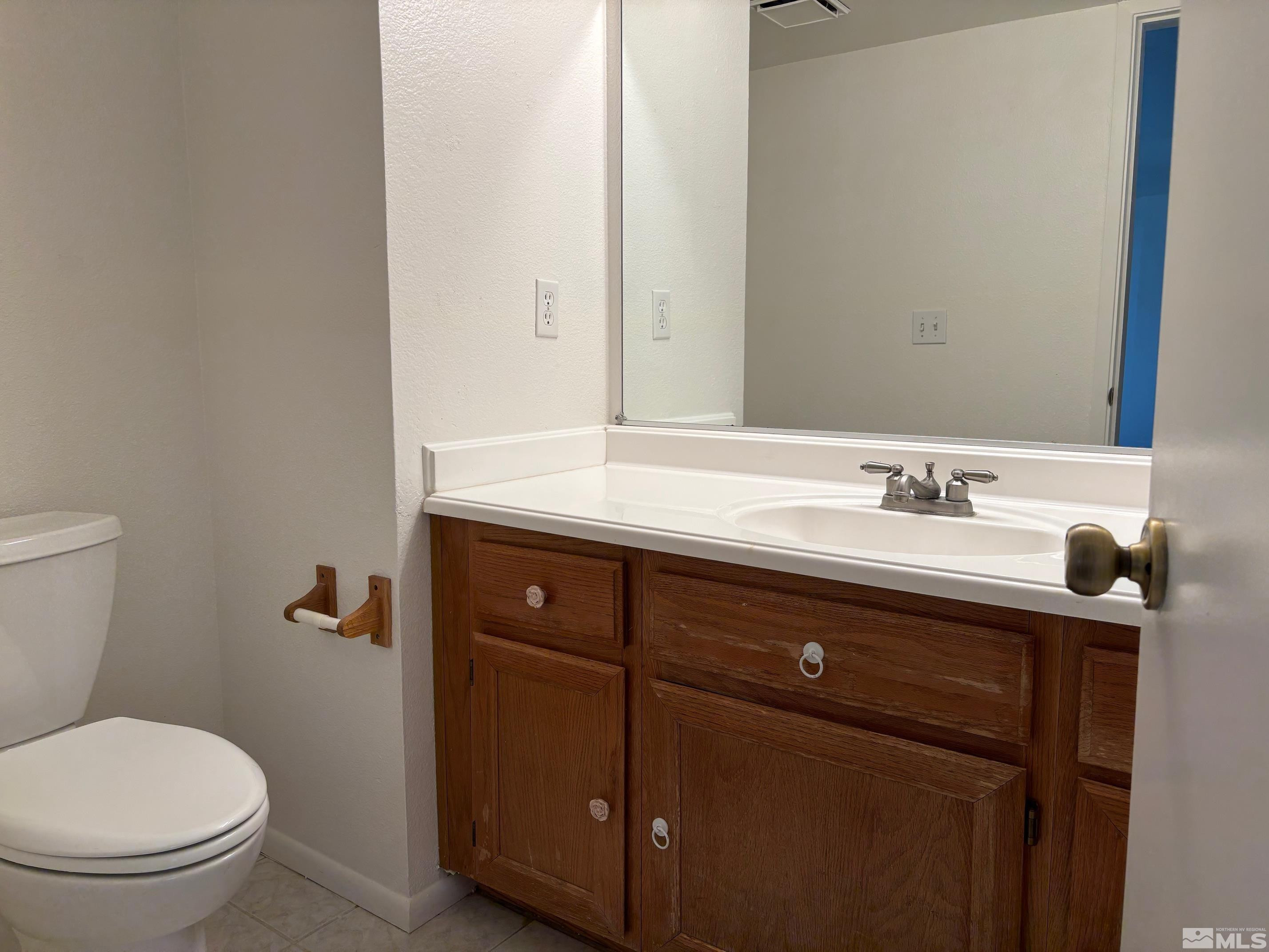 1721 Burnside Drive Sparks, NV 89434 - Photo 6 of 20 a bathroom with a sink a toilet and a mirror