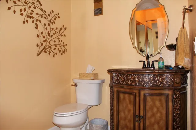a view of bathroom with a toilet and a mirror