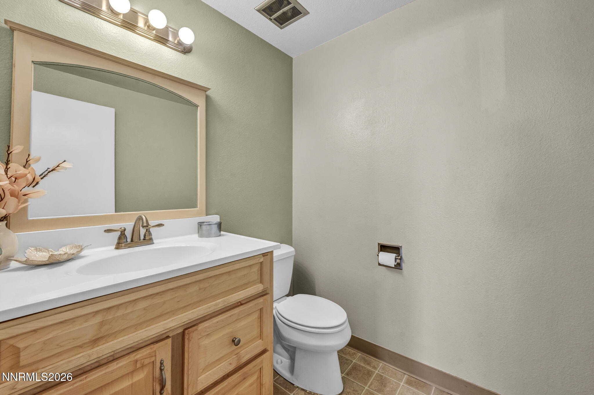 19 Condor Circle Carson City, NV 89701 - Photo 18 of 41 a bathroom with a granite countertop toilet sink mirror and vanity