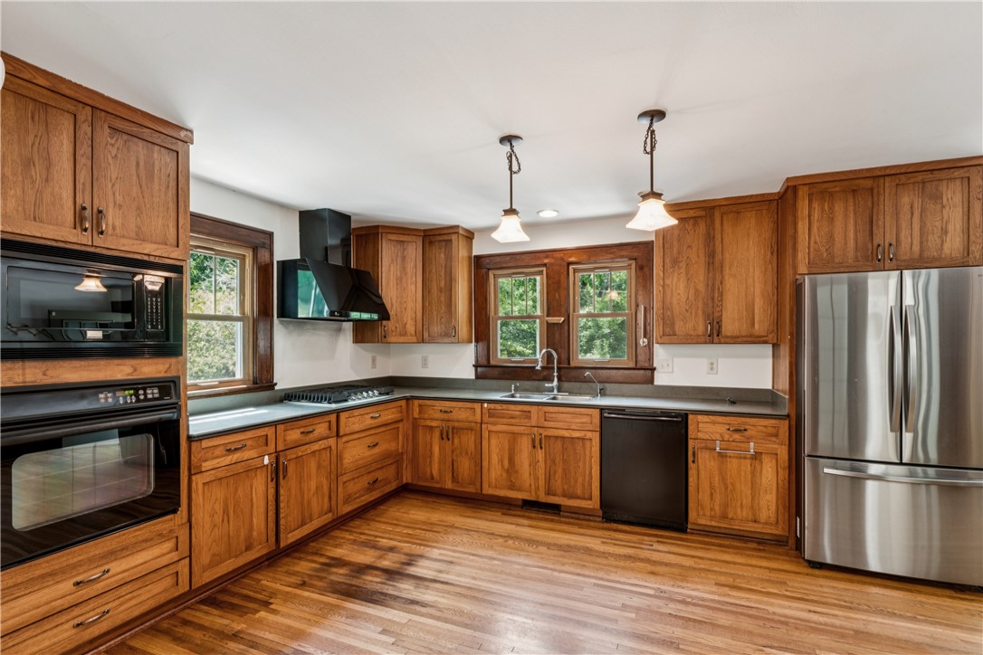 321 South Pine Street Walhalla, SC 29691 - Photo 3 of 32 Natural wood cabinetry and a gas range create a warm, inviting atmosphere in this functional kitchen.