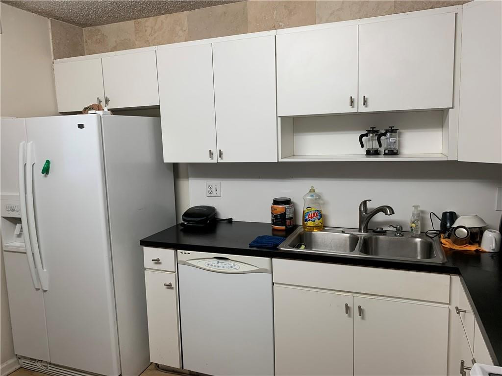 200 Southeast 15th Road, Unit 11H Miami, FL 33129 - Photo 26 of 35 a kitchen with a refrigerator and cabinets
