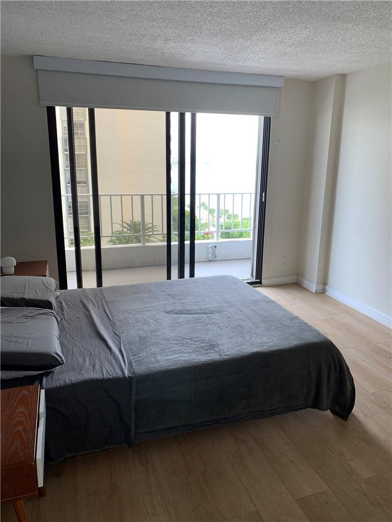 200 Southeast 15th Road, Unit 11H Miami, FL 33129 - Photo 27 of 35 a bedroom with a bed and window