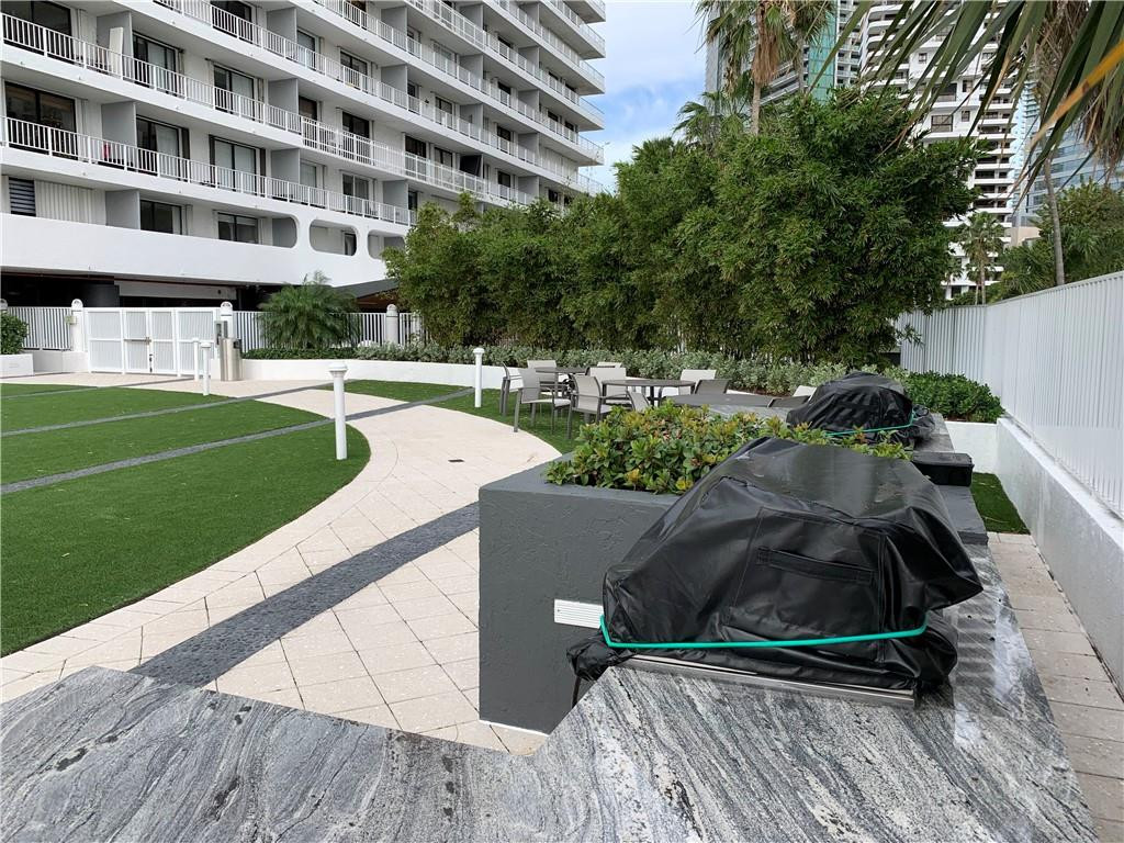 200 Southeast 15th Road, Unit 11H Miami, FL 33129 - Photo 5 of 35 a view of a swimming pool with a garden