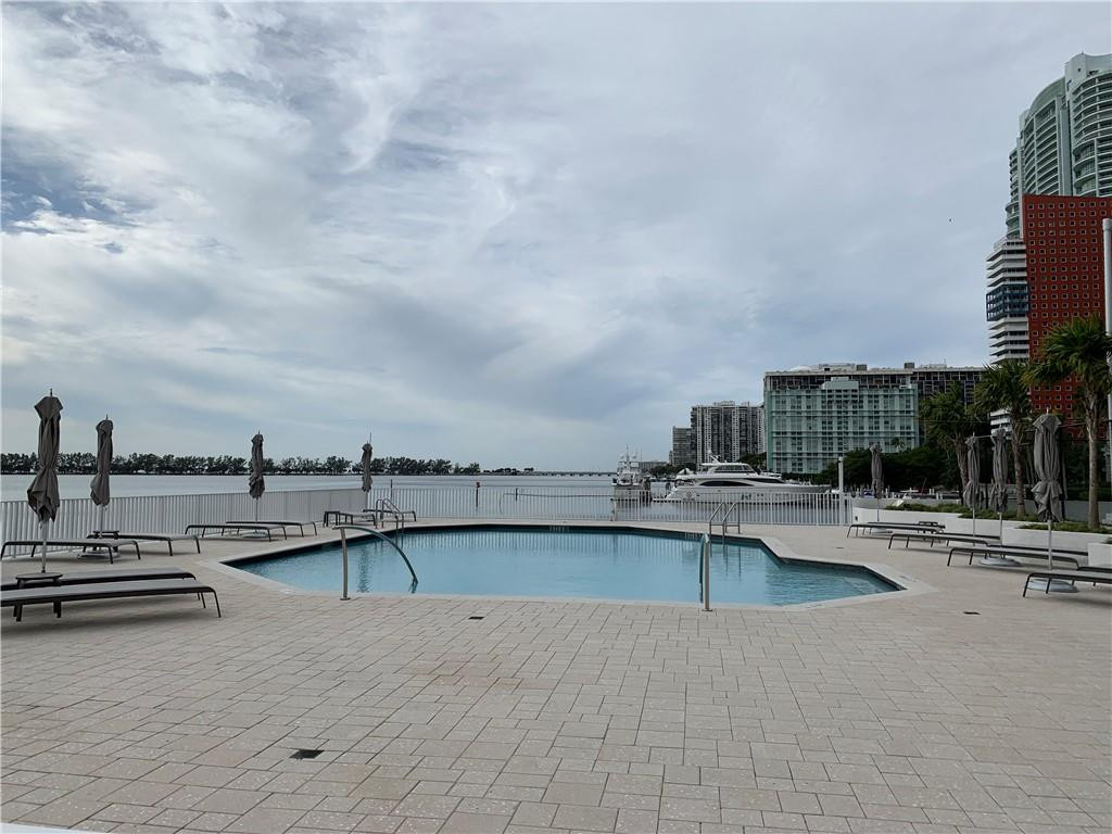 200 Southeast 15th Road, Unit 11H Miami, FL 33129 - Photo 9 of 35 a view of a swimming pool with outdoor seating