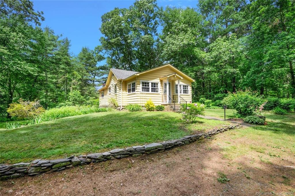 a view of a house with yard and a garden