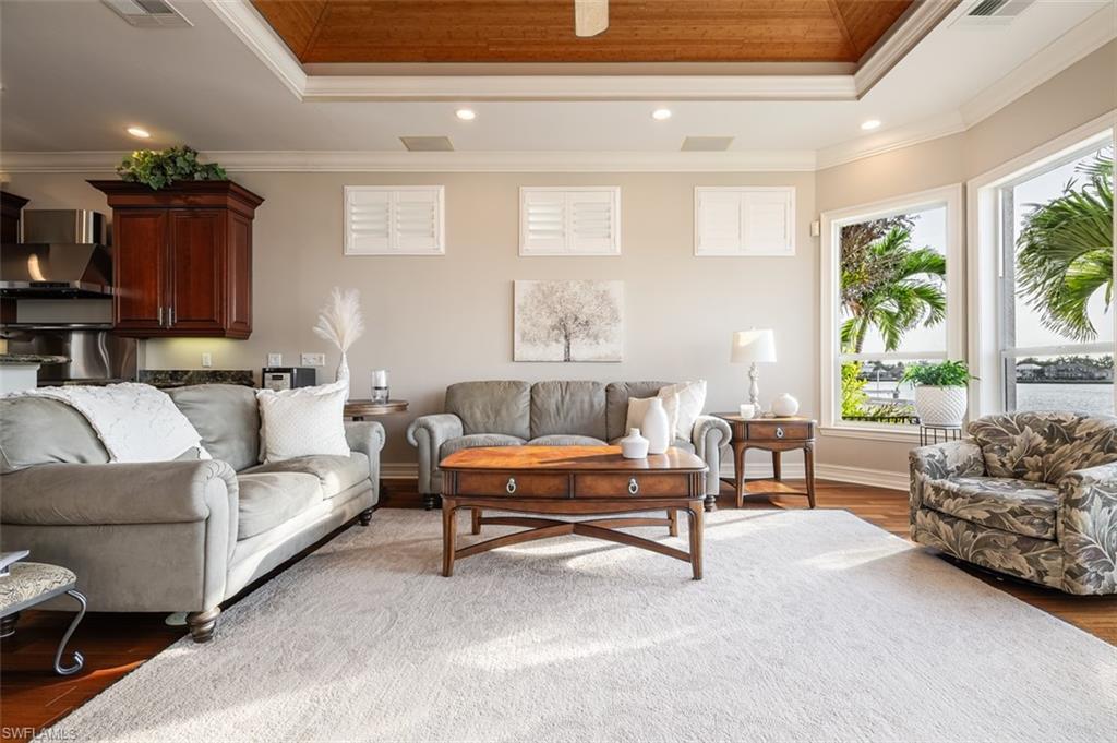 1942 Kingfish Road Naples, FL 34102 - Photo 12 of 43 a living room with furniture and a large window