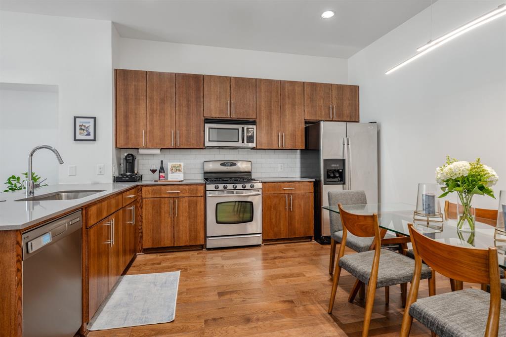 3930 Bowser Avenue, Unit 11 Dallas, TX 75219 - Photo 14 of 39 a kitchen with a sink a counter space cabinets and stainless steel appliances