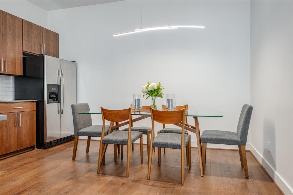 3930 Bowser Avenue, Unit 11 Dallas, TX 75219 - Photo 15 of 39 a view of a dining room with furniture and wooden floor