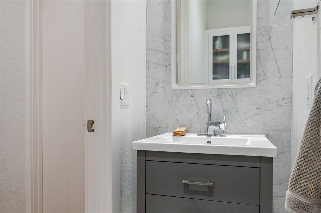 3930 Bowser Avenue, Unit 11 Dallas, TX 75219 - Photo 18 of 39 a bathroom with a sink and a mirror