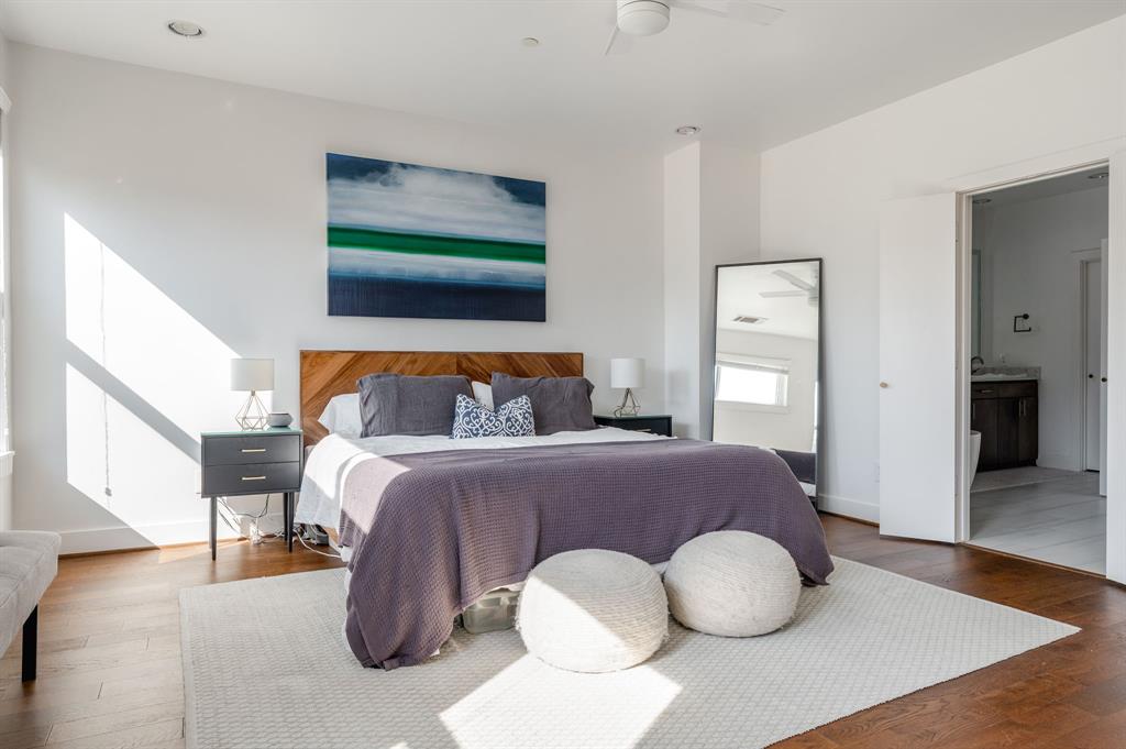 3930 Bowser Avenue, Unit 11 Dallas, TX 75219 - Photo 23 of 39 a bedroom with a bed and wooden floor