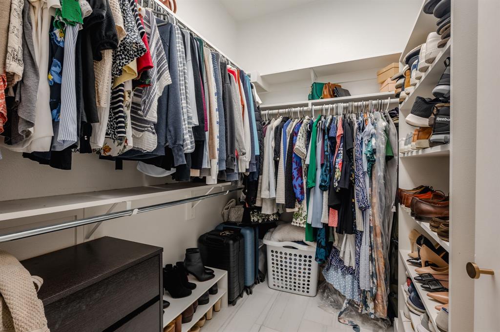 3930 Bowser Avenue, Unit 11 Dallas, TX 75219 - Photo 29 of 39 a view of walk in closet with clothes and shoes