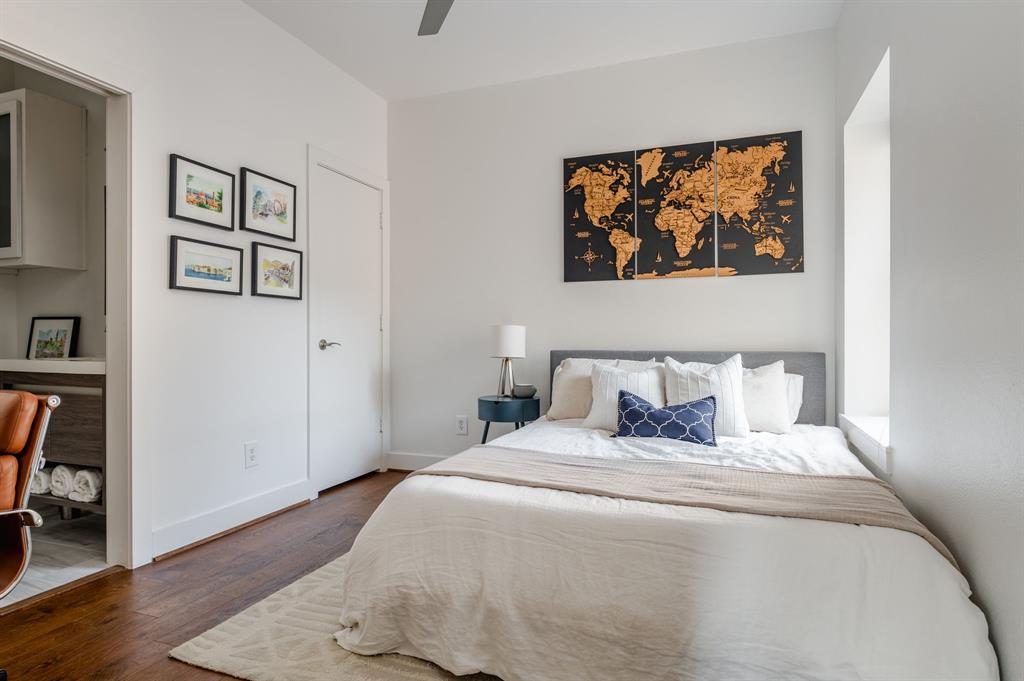 3930 Bowser Avenue, Unit 11 Dallas, TX 75219 - Photo 30 of 39 a bedroom with a bed and a painting on the wall