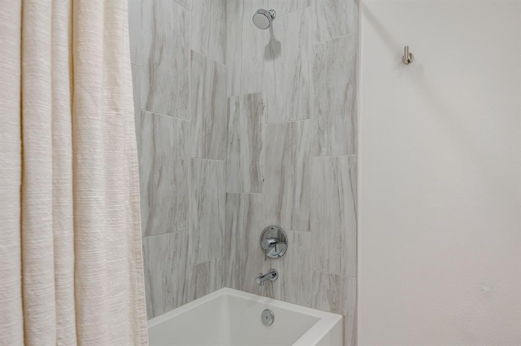 3930 Bowser Avenue, Unit 11 Dallas, TX 75219 - Photo 33 of 39 a bathroom with bathtub and shower