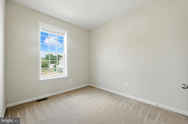 a bedroom with a bed potted plant and a window