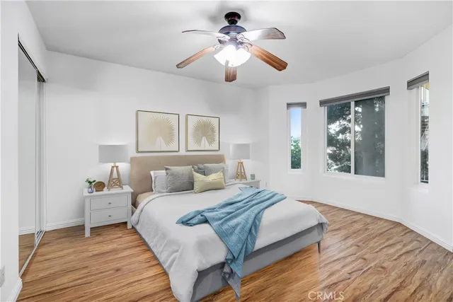 a bedroom with a large bed and a window