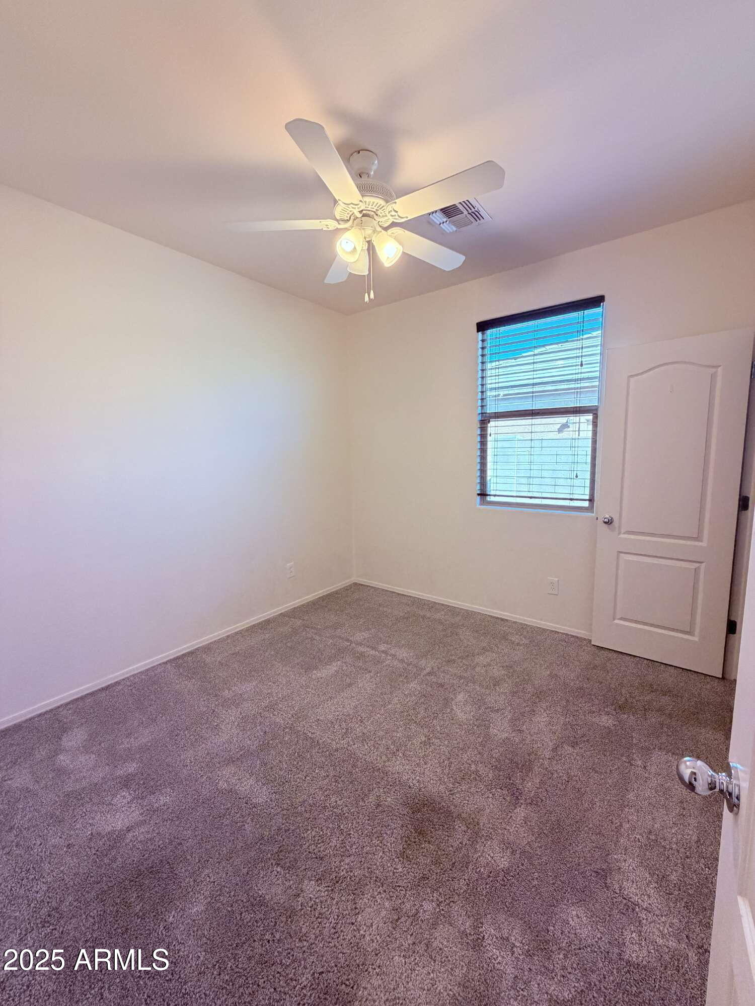 21121 East Via De Olivos Queen Creek, AZ 85142 - Photo 21 of 34 an empty room with windows and fan