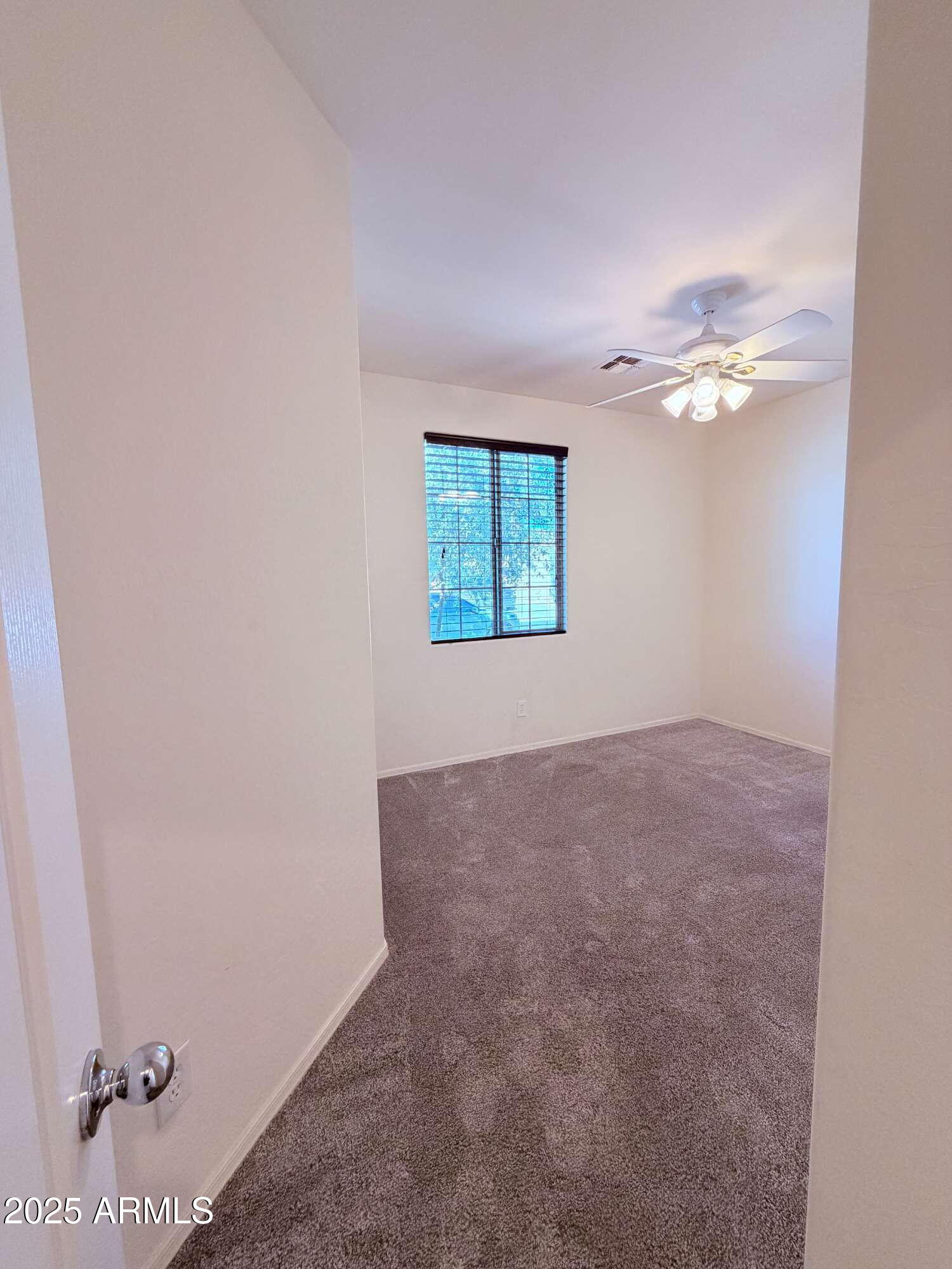 21121 East Via De Olivos Queen Creek, AZ 85142 - Photo 25 of 34 an empty room with windows and fan
