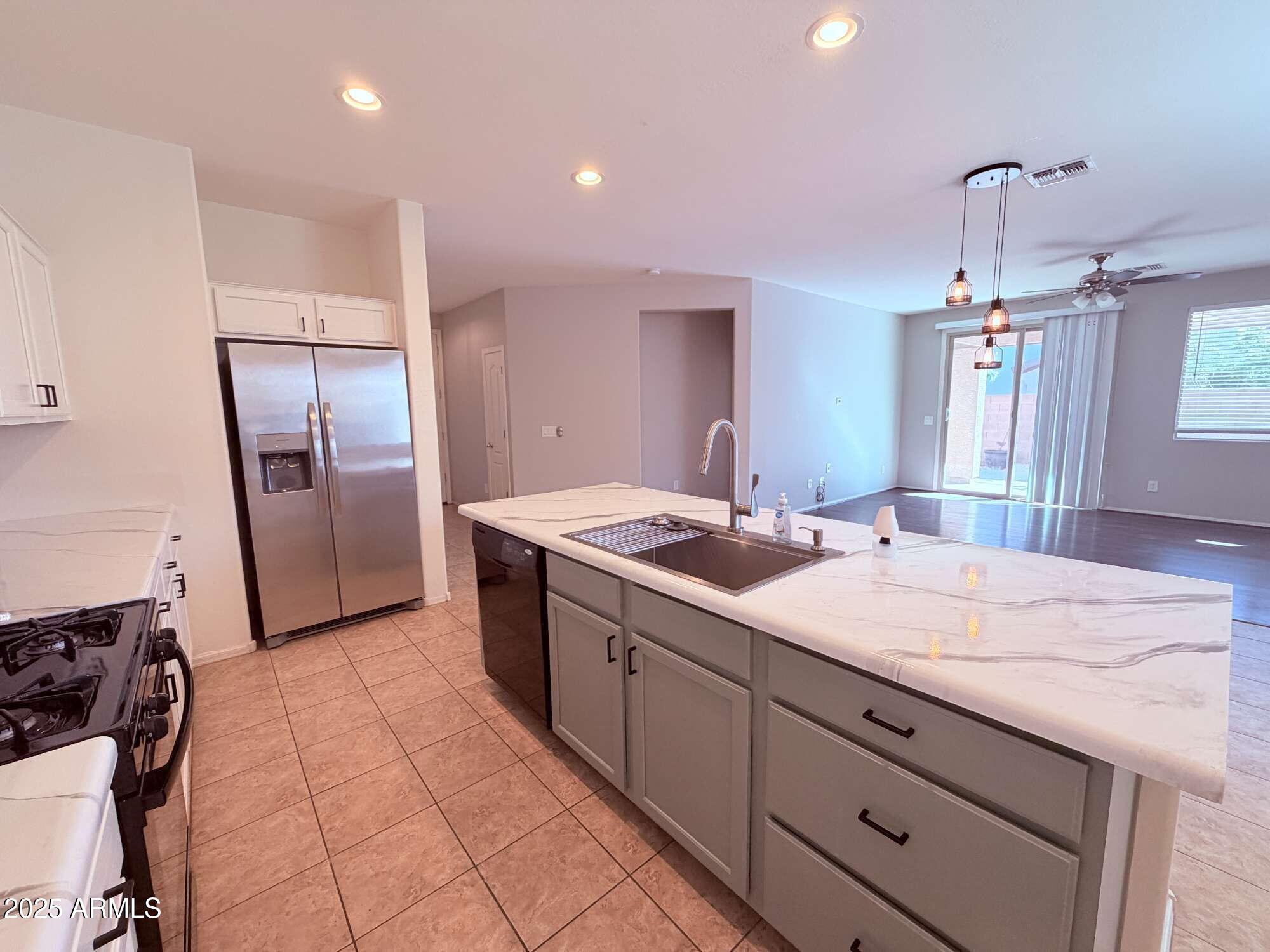 21121 East Via De Olivos Queen Creek, AZ 85142 - Photo 7 of 34 a kitchen with a sink refrigerator and microwave