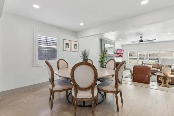 a dining room with furniture and wooden floor