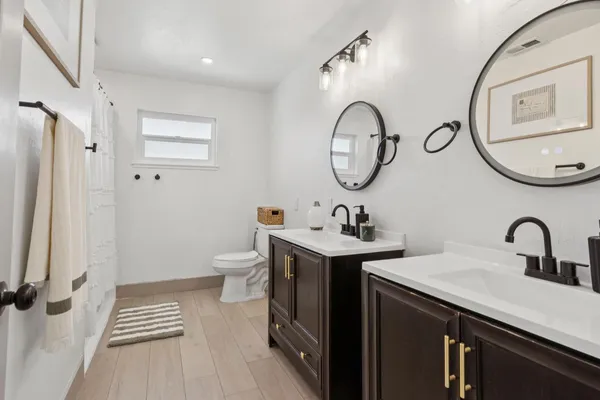 a bathroom with a toilet a sink and a mirror