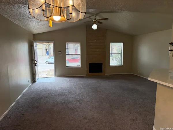 a view of a livingroom with a ceiling fan and window