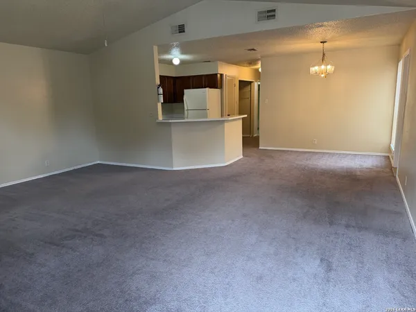 a view of a kitchen with a sink and white cabinets