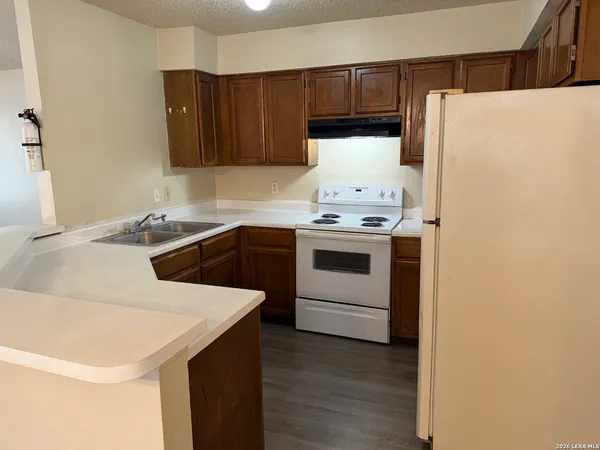 a kitchen with a sink a stove and refrigerator