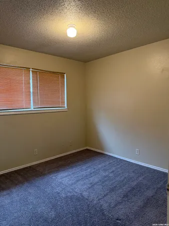 an empty room with a empty space and windows