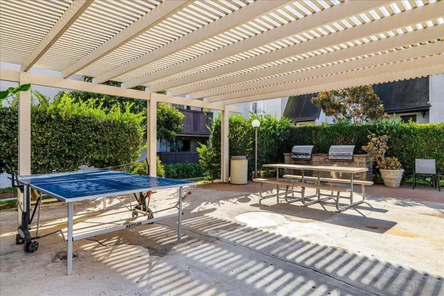 a building outdoor space with patio furniture and potted plants