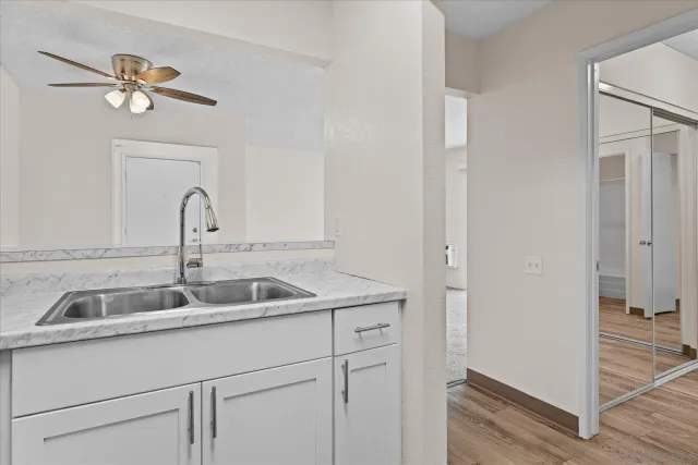 a close view of a sink and cabinets