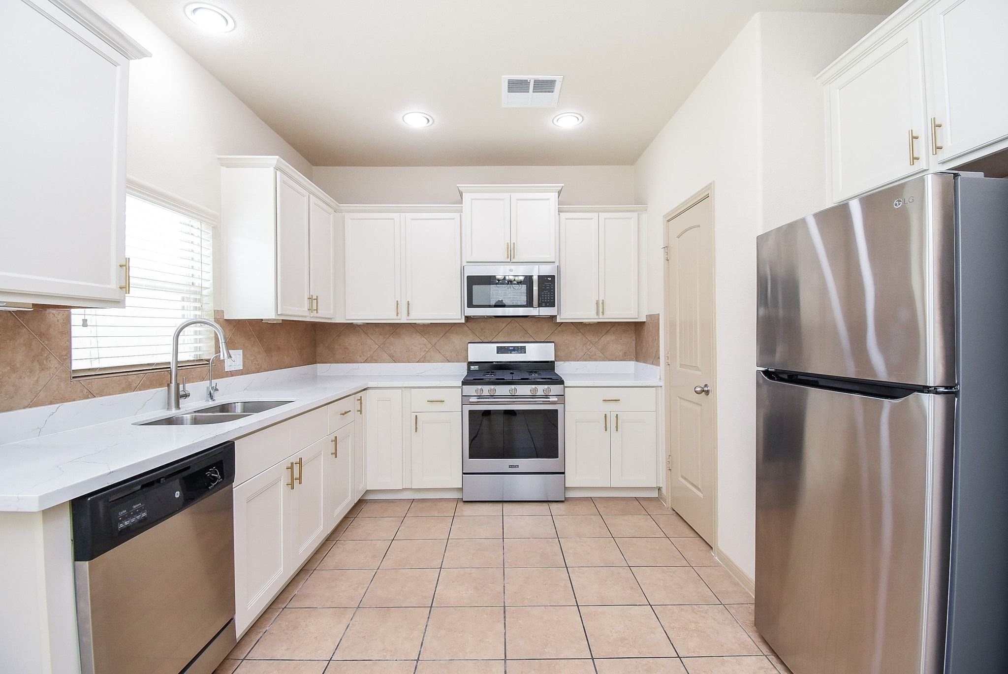 2106 Harmon Crest Court Spring, TX 77373 - Photo 12 of 37 a kitchen with a refrigerator sink and cabinets