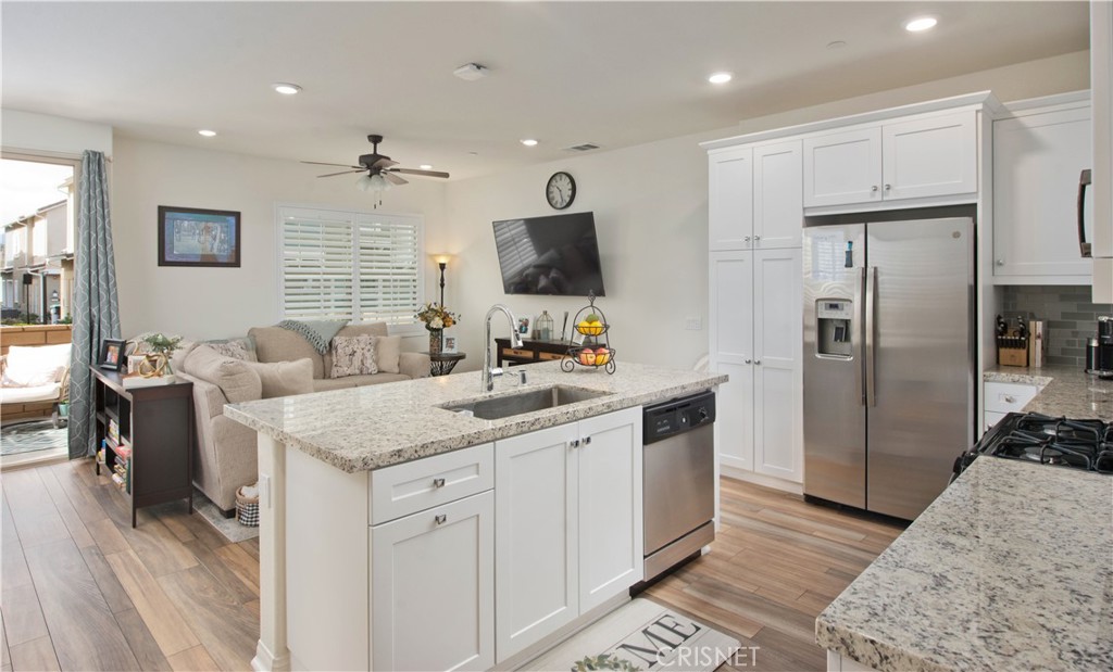 22880 Concord Drive Saugus, CA 91350 - Photo 12 of 34 a kitchen with stainless steel appliances granite countertop a refrigerator and a sink