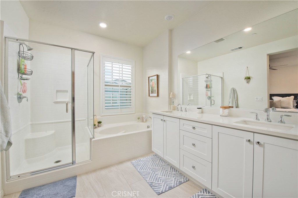 22880 Concord Drive Saugus, CA 91350 - Photo 22 of 34 a spacious bathroom with a shower a sink and a mirror