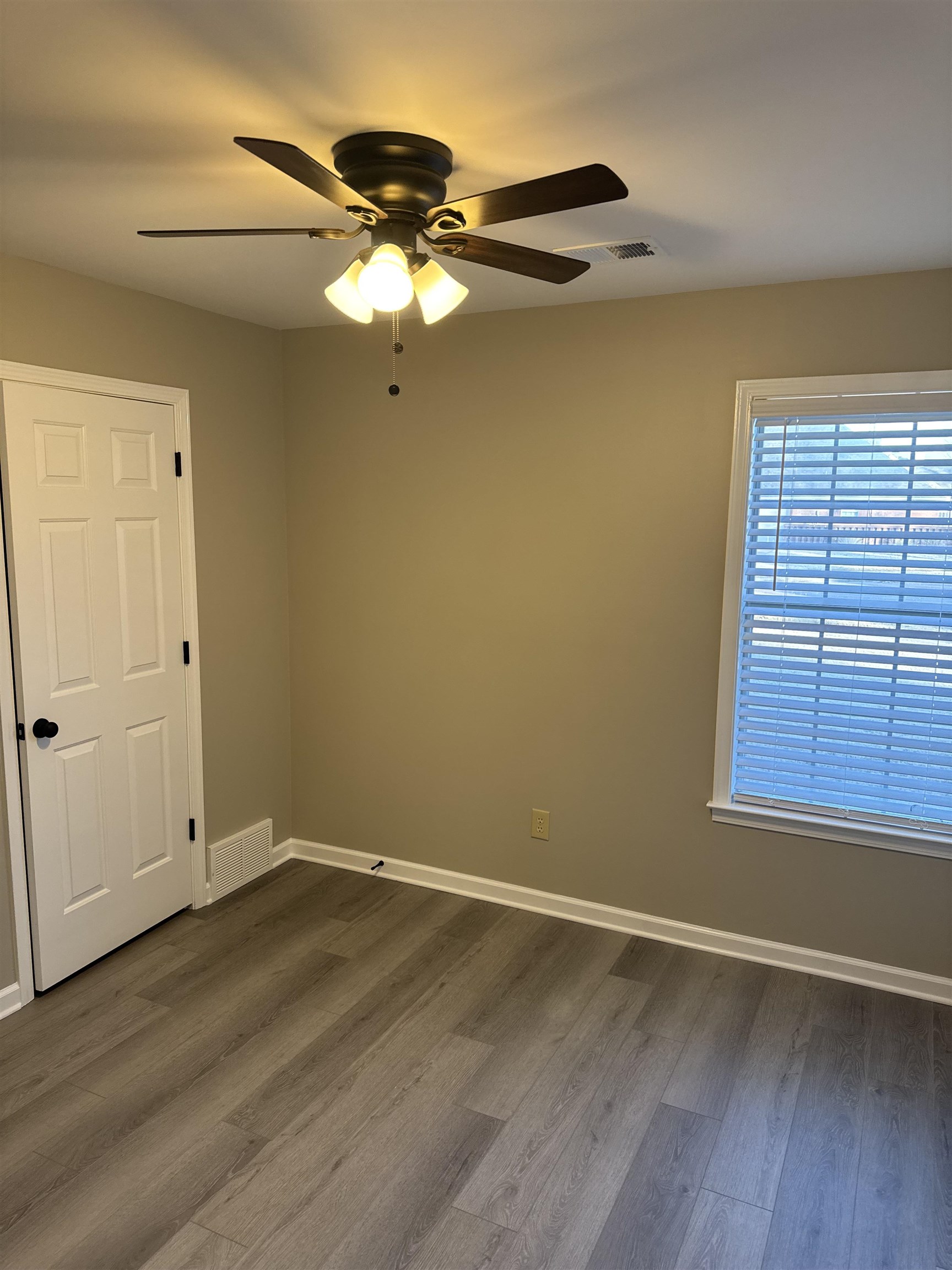 6333 Daybreak Drive Bartlett, TN 38135 - Photo 15 of 21 a view of an empty room with wooden floor and a window