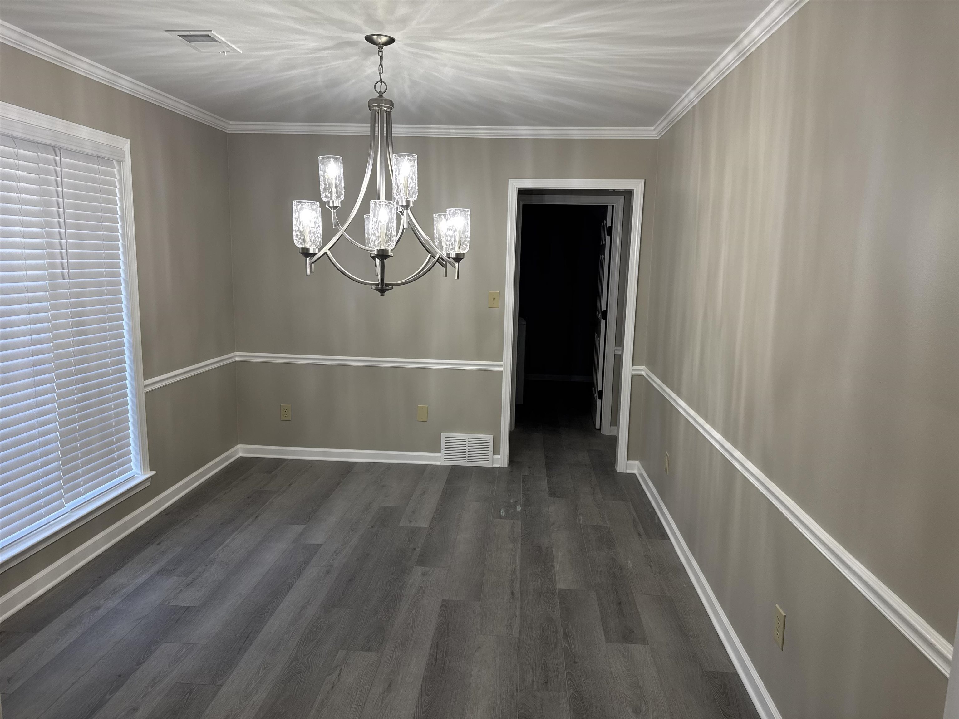 6333 Daybreak Drive Bartlett, TN 38135 - Photo 7 of 21 a view of a hallway with wooden floor and chandelier