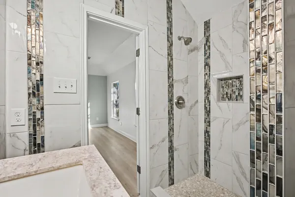 a bathroom with a granite countertop shower