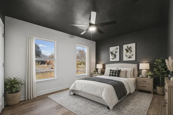 a bedroom with a large bed and a potted plant