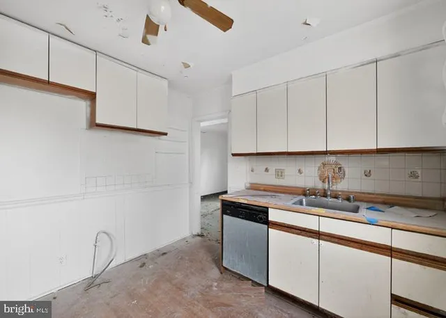 a kitchen with a stove a sink and a window