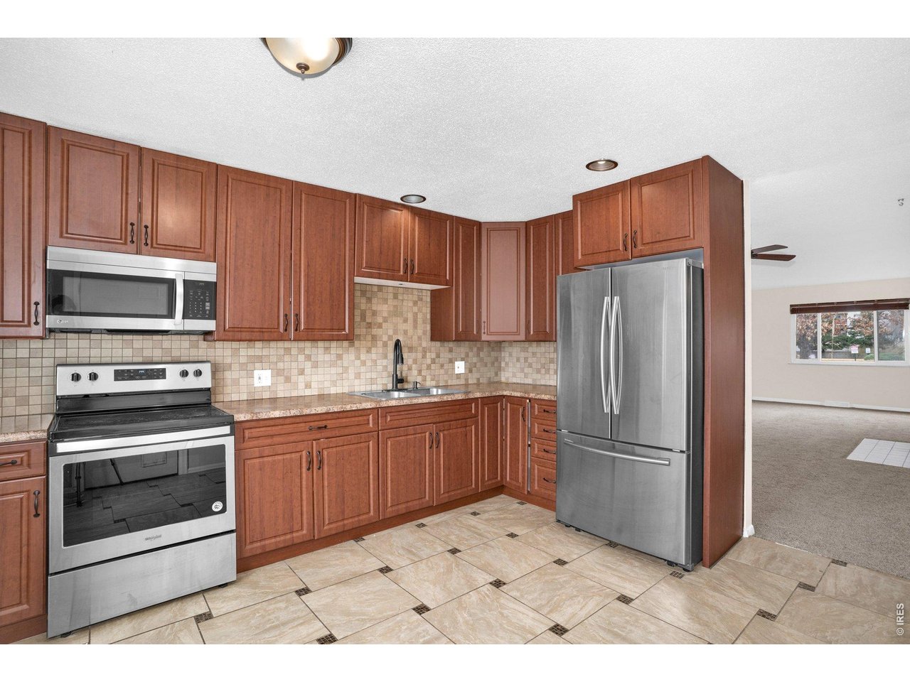 2616 23rd Avenue Greeley, CO 80634 - Photo 14 of 21 a kitchen with a refrigerator sink and microwave