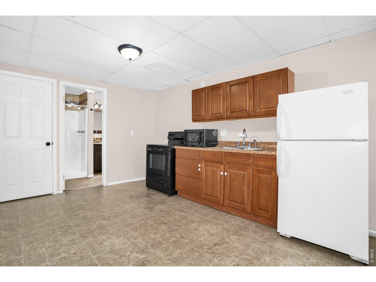 2616 23rd Avenue Greeley, CO 80634 - Photo 19 of 21 a kitchen with refrigerator and cabinets