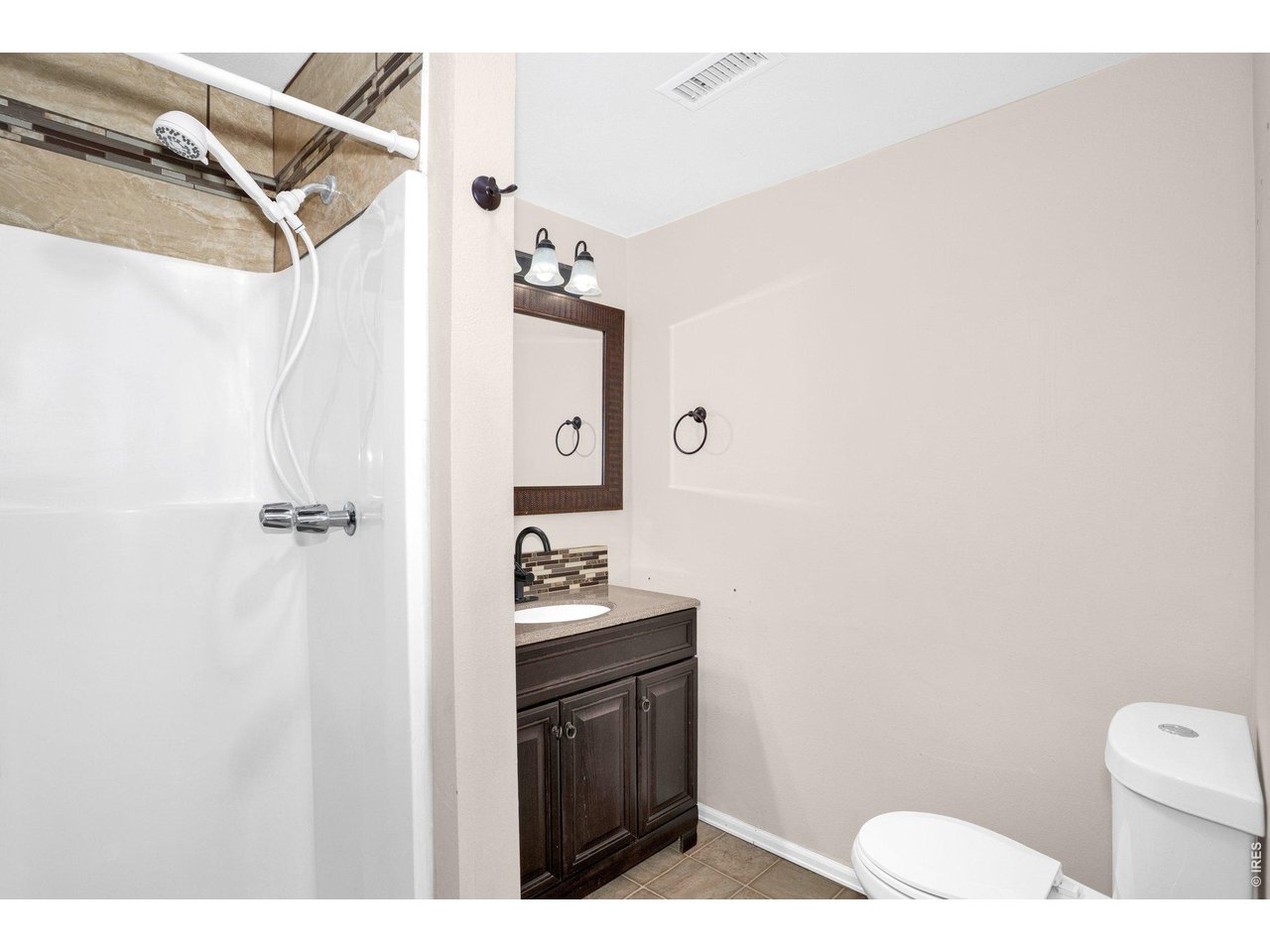 2616 23rd Avenue Greeley, CO 80634 - Photo 21 of 21 a bathroom with a toilet sink and mirror