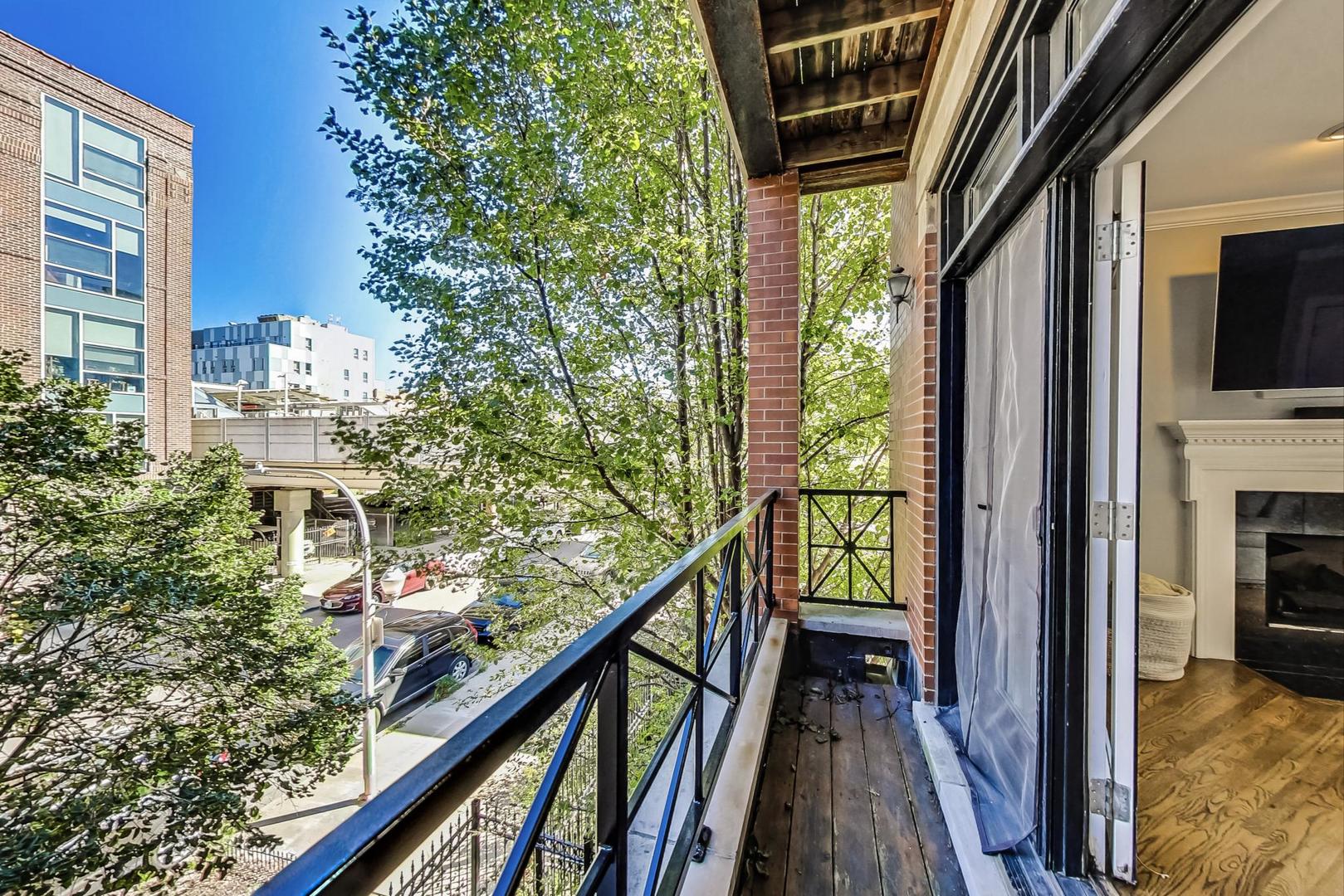 951 West Fletcher Street, Unit 2 Chicago, IL 60657 - Photo 11 of 26 a view of balcony with wooden floor and stairs