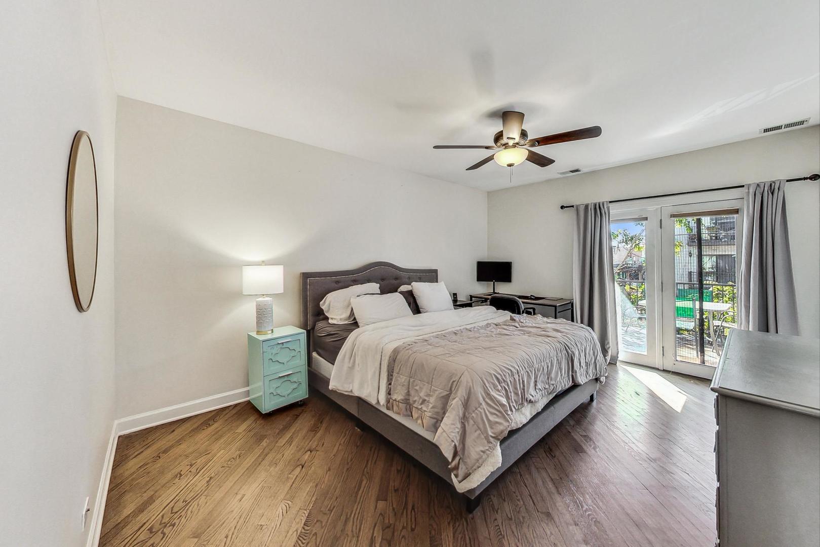 951 West Fletcher Street, Unit 2 Chicago, IL 60657 - Photo 12 of 26 a bedroom with a bed and a chandelier