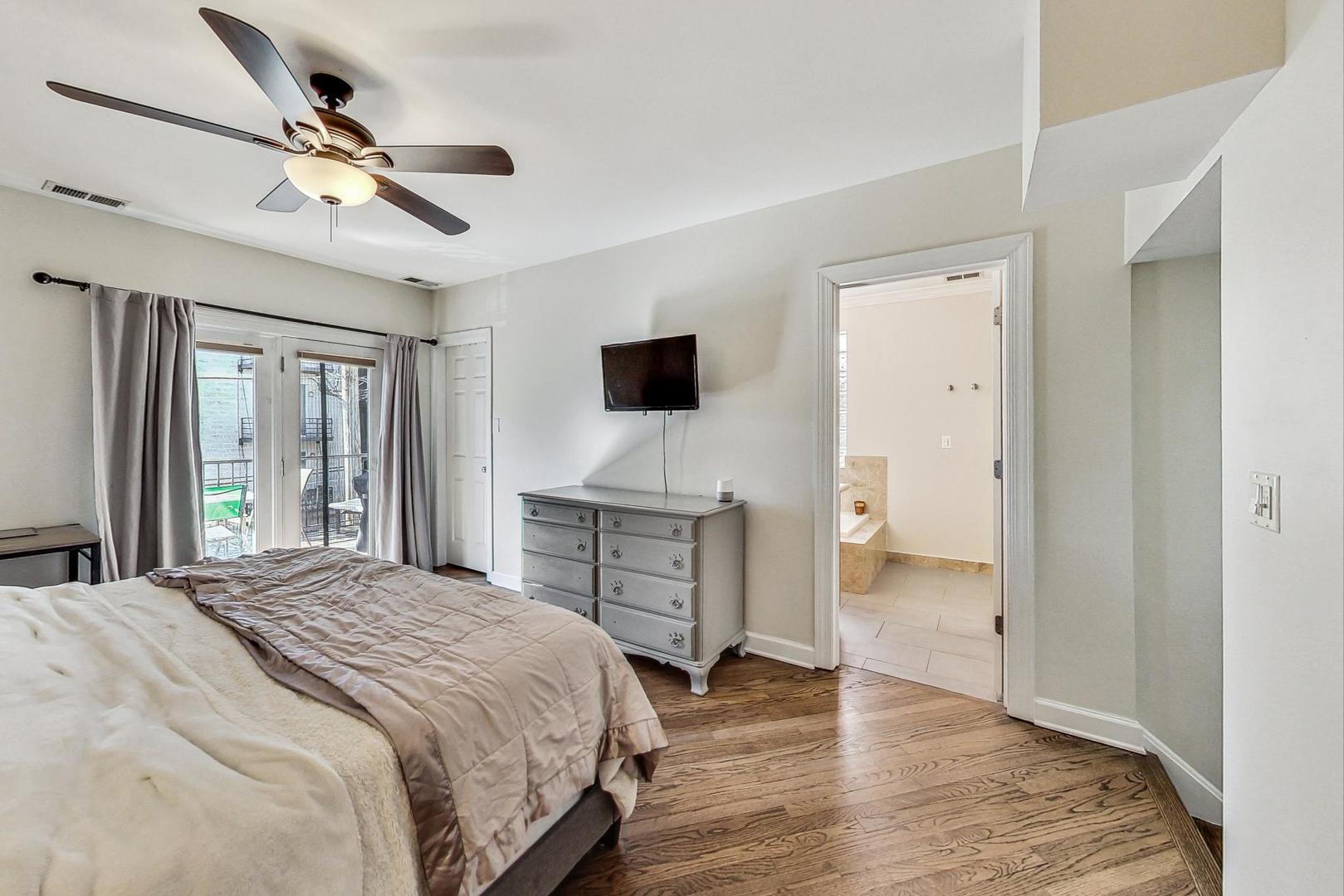 951 West Fletcher Street, Unit 2 Chicago, IL 60657 - Photo 13 of 26 a bedroom with a bed and a flat screen tv