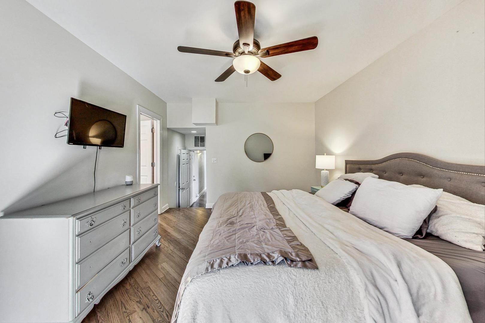 951 West Fletcher Street, Unit 2 Chicago, IL 60657 - Photo 14 of 26 a bedroom with a large bed and a flat screen tv