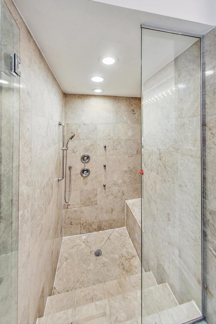 951 West Fletcher Street, Unit 2 Chicago, IL 60657 - Photo 17 of 26 a bathroom with a shower and a glass door