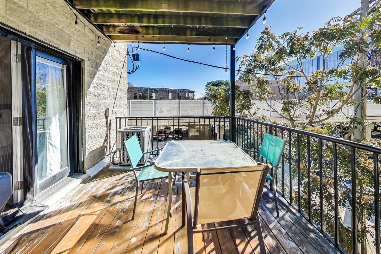 951 West Fletcher Street, Unit 2 Chicago, IL 60657 - Photo 25 of 26 a view of a balcony with table and chairs