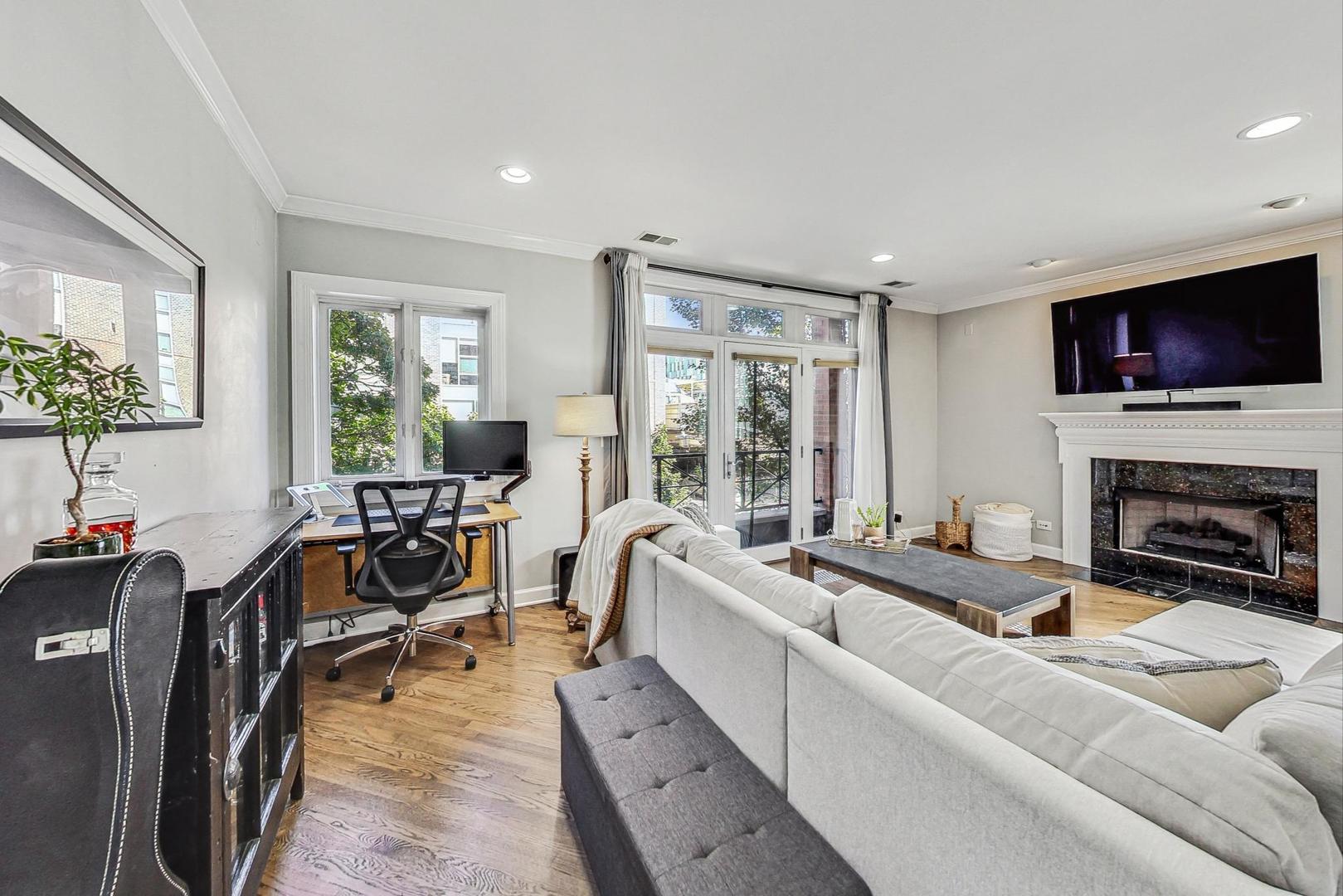951 West Fletcher Street, Unit 2 Chicago, IL 60657 - Photo 5 of 26 a living room with fireplace furniture and a flat screen tv